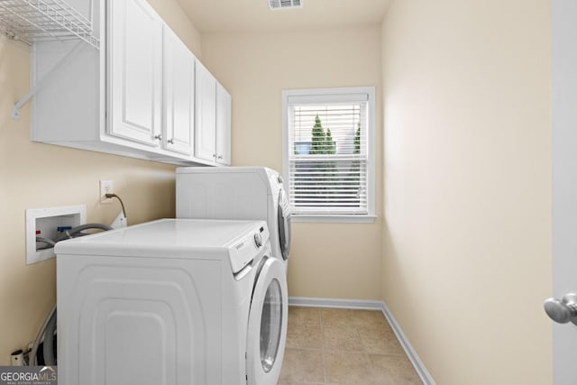 2694 Dawning Day Dr, Dacula, GA 30019 - clothes washing area with independent washer and dryer, light tile patterned flooring, cabinet space, baseboards, and visible vents