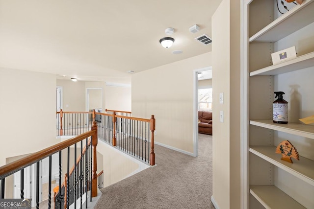 2694 Dawning Day Dr, Dacula, GA 30019 - hall with baseboards, visible vents, carpet flooring, and an upstairs landing