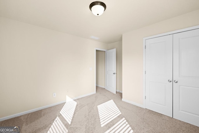 2694 Dawning Day Dr, Dacula, GA 30019 - unfurnished bedroom featuring baseboards, light carpet, and a closet