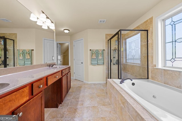 2694 Dawning Day Dr, Dacula, GA 30019 - full bath with visible vents, a shower stall, a sink, and a garden tub