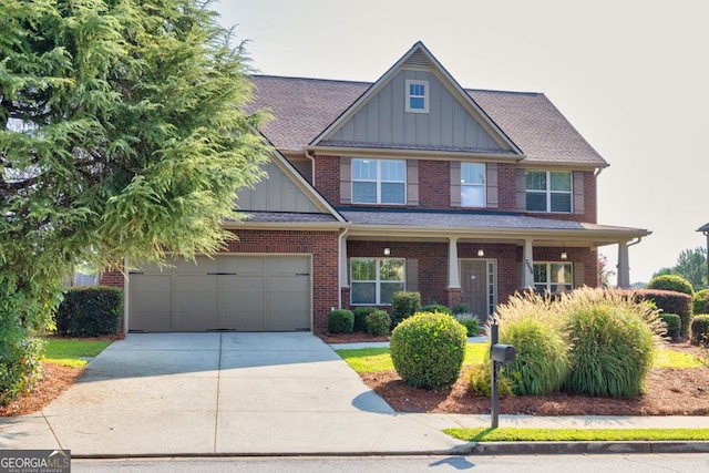 2694 Dawning Day Dr, Dacula, GA 30019 - craftsman house featuring roof with shingles, brick siding, board and batten siding, an attached garage, and driveway