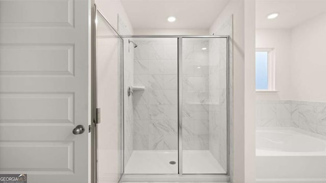 1129 Blue Juniper Cir, Loganville, GA 30052 - full bathroom featuring a garden tub, recessed lighting, and a stall shower