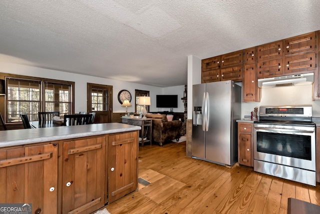 80 Lake Forest Ct, Lakemont, GA 30552 - kitchen featuring stainless steel appliances, under cabinet range hood, light wood finished floors, a textured ceiling, and light countertops