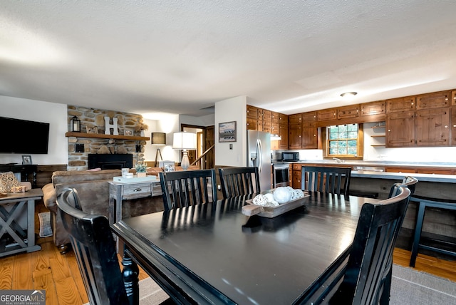 80 Lake Forest Ct, Lakemont, GA 30552 - dining room with light wood finished floors and a fireplace