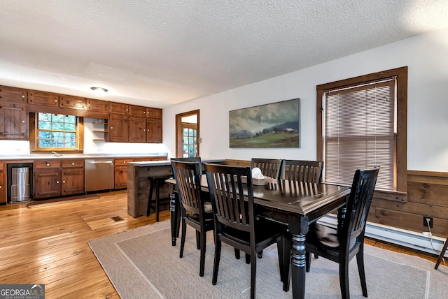 80 Lake Forest Ct, Lakemont, GA 30552 - dining area featuring a textured ceiling, light wood-type flooring, and wainscoting