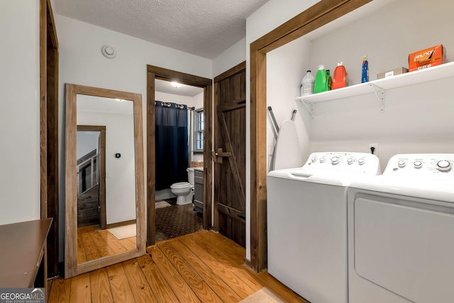 80 Lake Forest Ct, Lakemont, GA 30552 - washroom with separate washer and dryer, light wood-type flooring, and a textured ceiling