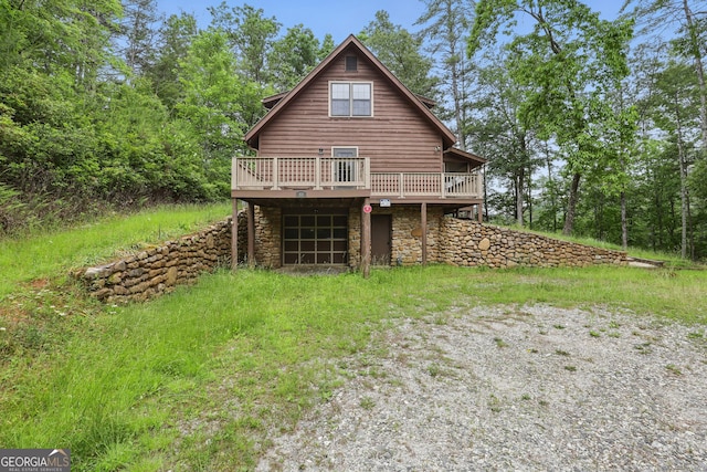 80 Lake Forest Ct, Lakemont, GA 30552 - rear view of house with stone siding, a wooden deck, driveway, and an attached garage