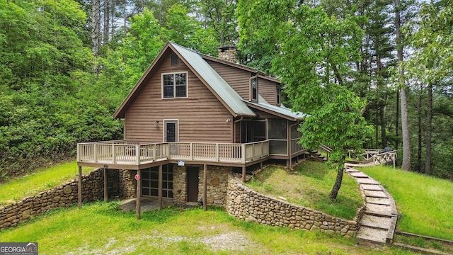 80 Lake Forest Ct, Lakemont, GA 30552 - back of house featuring a sunroom, a deck, a chimney, metal roof, and a lawn