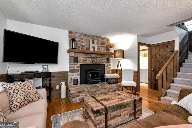 80 Lake Forest Ct, Lakemont, GA 30552 - living area featuring hardwood / wood-style floors, a textured ceiling, stairway, and a stone fireplace