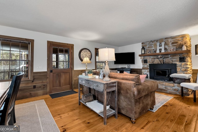 80 Lake Forest Ct, Lakemont, GA 30552 - living area with wainscoting, light wood finished floors, a fireplace, and a textured ceiling