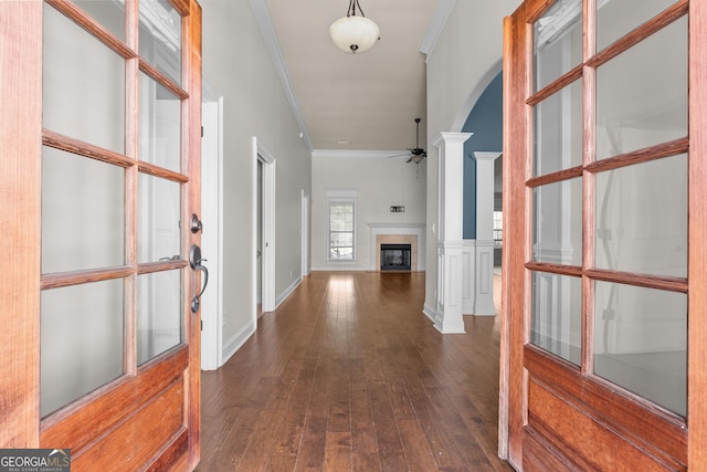 157 Wessex Dr, Bonaire, GA 31005 - entrance foyer featuring crown molding, arched walkways, ceiling fan, dark wood-style floors, and a fireplace