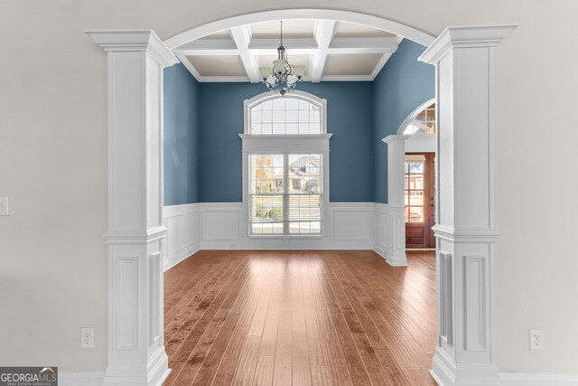 157 Wessex Dr, Bonaire, GA 31005 - empty room with coffered ceiling, wood-type flooring, beam ceiling, a wainscoted wall, and a chandelier