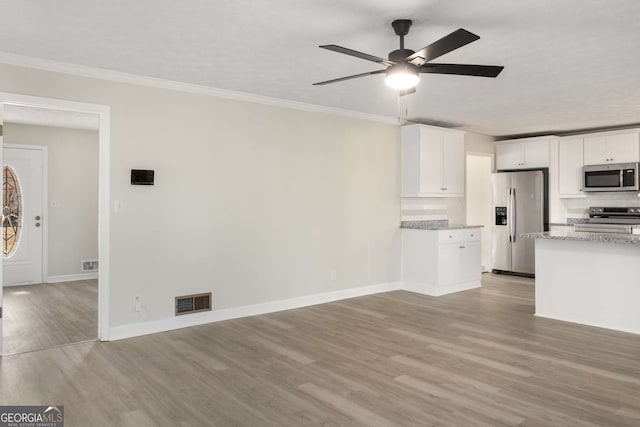 2694 Hickory Valley Dr, Snellville, GA 30078 - unfurnished living room with light wood-type flooring, ornamental molding, baseboards, visible vents, and a ceiling fan