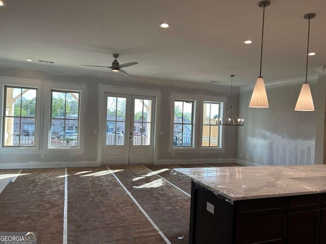 kitchen featuring visible vents, baseboards, recessed lighting, light stone counters, and open floor plan