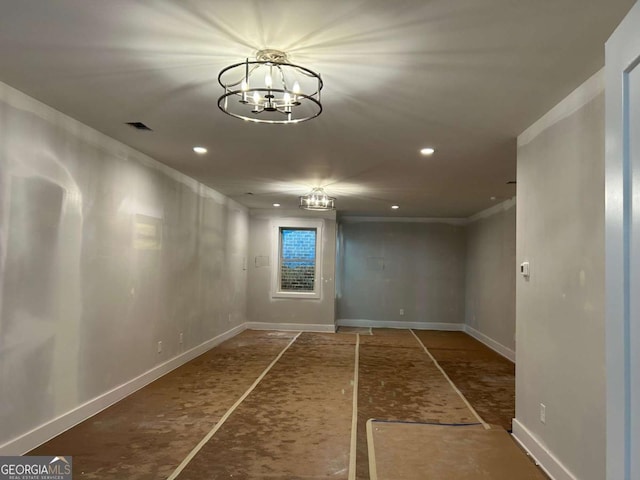 empty room with baseboards, crown molding, recessed lighting, and an inviting chandelier