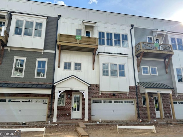 multi unit property with brick siding, a standing seam roof, and board and batten siding
