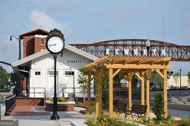 view of property's community featuring a pergola and fence