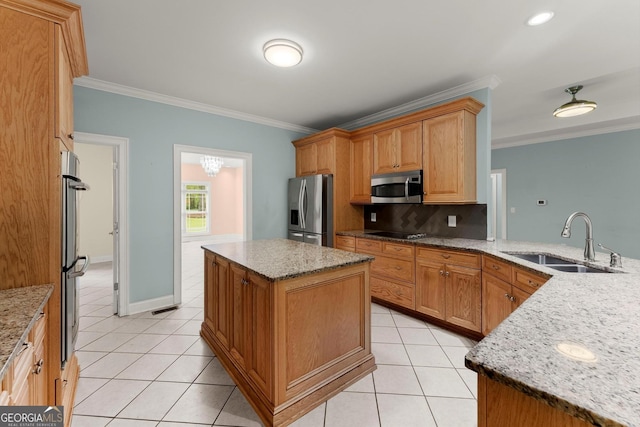 kitchen featuring a sink, ornamental molding, appliances with stainless steel finishes, and light tile patterned floors