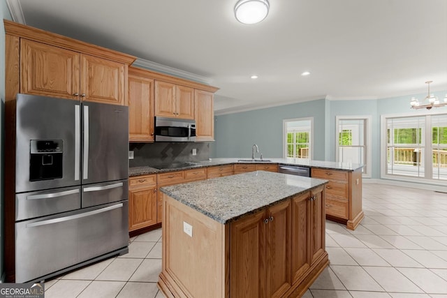 kitchen featuring a sink, ornamental molding, a peninsula, stainless steel appliances, and light tile patterned flooring
