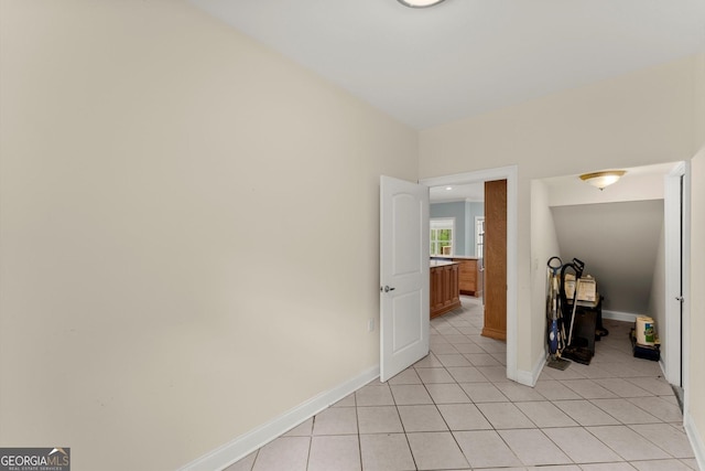 unfurnished bedroom with baseboards and light tile patterned flooring