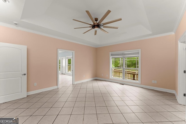 unfurnished room featuring a raised ceiling, crown molding, and a ceiling fan
