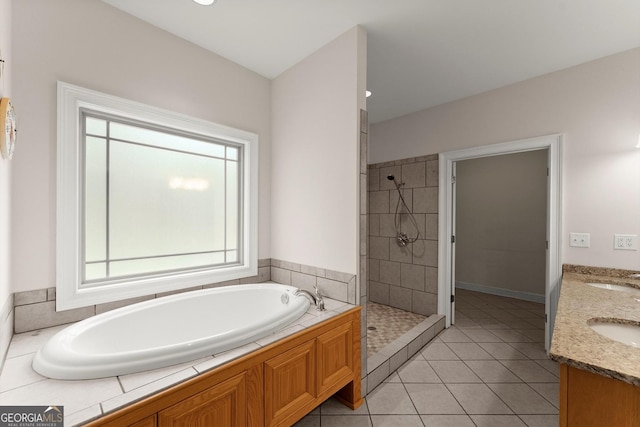 bathroom with a shower stall, a garden tub, a sink, and tile patterned flooring