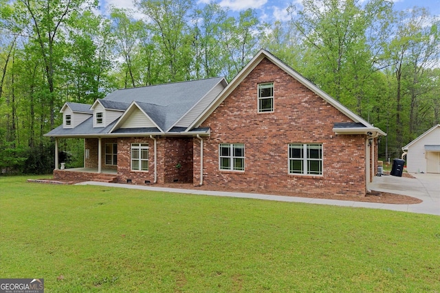 craftsman-style house featuring a front yard, brick siding, driveway, and a porch