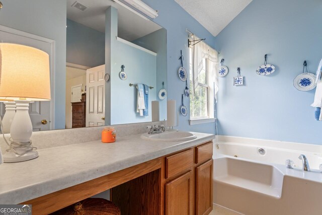 726 Fir Chase, Fairburn, GA 30213 - full bath with vanity, vaulted ceiling, a textured ceiling, a garden tub, and visible vents