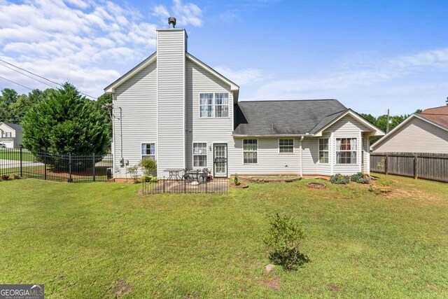 726 Fir Chase, Fairburn, GA 30213 - rear view of house with a chimney, a patio, fence private yard, and a lawn
