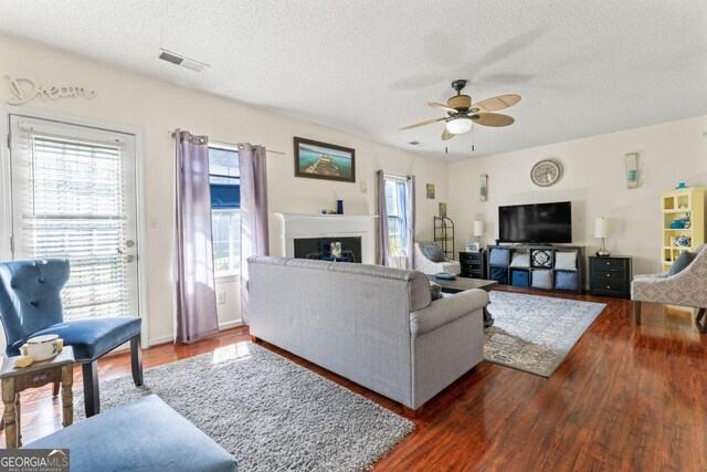 726 Fir Chase, Fairburn, GA 30213 - living room featuring wood finished floors, visible vents, a textured ceiling, and ceiling fan