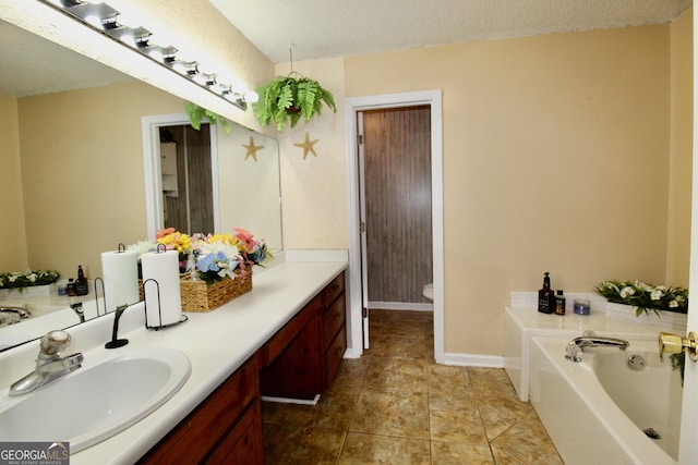 3789 Heatherwoods Dr, Valdosta, GA 31605 - bathroom with toilet, a bath, vanity, and baseboards
