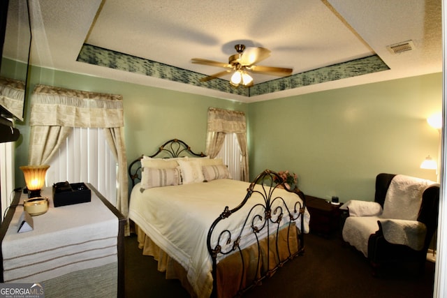 3789 Heatherwoods Dr, Valdosta, GA 31605 - bedroom featuring a raised ceiling, a textured ceiling, and carpet
