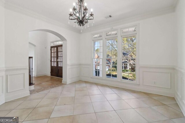 unfurnished living room featuring crown molding, a tray ceiling, baseboards, ceiling fan, and wood finished floors