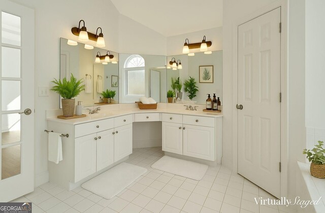 bathroom with tile patterned floors, enclosed tub / shower combo, double vanity, and a sink