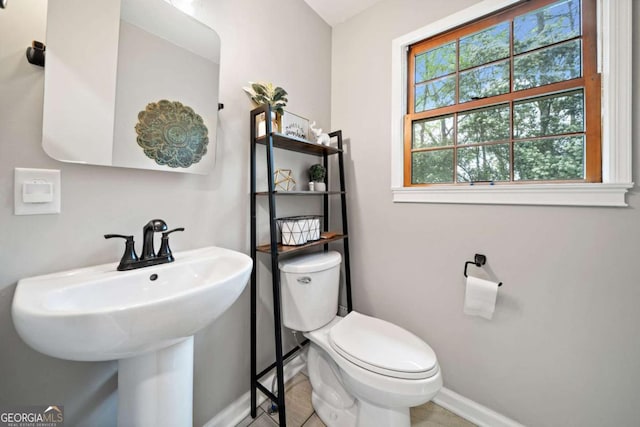 6695 Woodstock Rd, Acworth, GA 30102 - half bathroom featuring toilet, a sink, and baseboards
