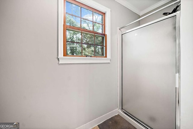 6695 Woodstock Rd, Acworth, GA 30102 - bathroom with a stall shower, baseboards, and crown molding