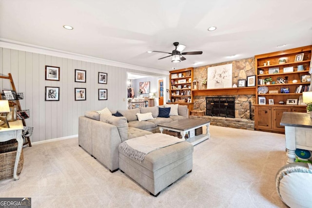 6695 Woodstock Rd, Acworth, GA 30102 - living room with a ceiling fan, light carpet, a stone fireplace, and built in shelves