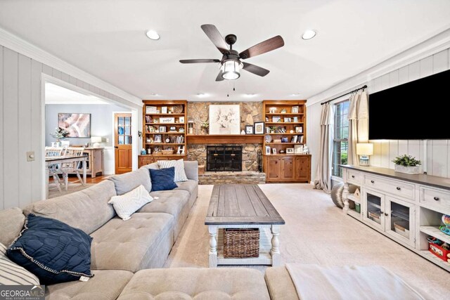 6695 Woodstock Rd, Acworth, GA 30102 - living room with light colored carpet, built in shelves, a fireplace, and ceiling fan