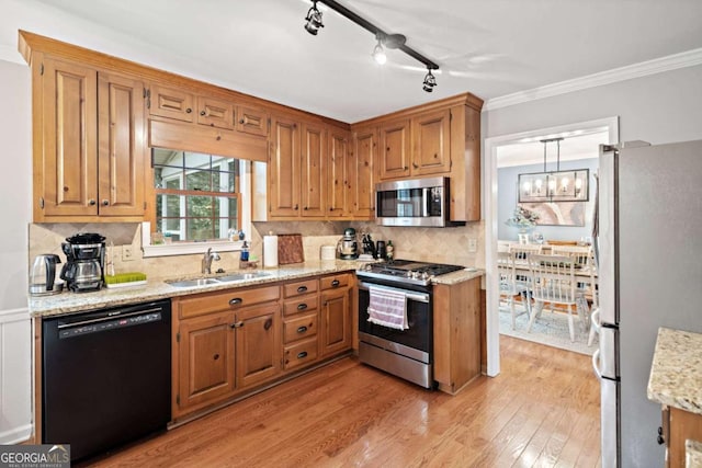 6695 Woodstock Rd, Acworth, GA 30102 - kitchen featuring a sink, light wood-type flooring, stainless steel appliances, ornamental molding, and an inviting chandelier