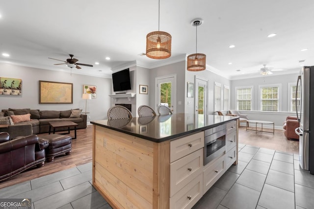1081 Katherine Ln, Greensboro, GA 30642 - kitchen featuring open floor plan, crown molding, appliances with stainless steel finishes, and a ceiling fan