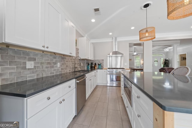 1081 Katherine Ln, Greensboro, GA 30642 - kitchen featuring visible vents, a sink, wall chimney range hood, appliances with stainless steel finishes, and backsplash