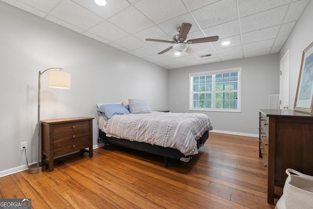 1081 Katherine Ln, Greensboro, GA 30642 - bedroom with visible vents, baseboards, ceiling fan, a paneled ceiling, and wood-type flooring