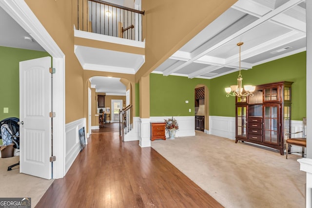 80 Lanier Rdg, Acworth, GA 30101 - carpeted foyer entrance with arched walkways, beam ceiling, a chandelier, and coffered ceiling