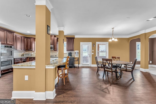 80 Lanier Rdg, Acworth, GA 30101 - dining area featuring dark wood-style floors, arched walkways, crown molding, and visible vents
