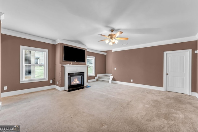 80 Lanier Rdg, Acworth, GA 30101 - unfurnished living room with a ceiling fan, light carpet, crown molding, baseboards, and a glass covered fireplace