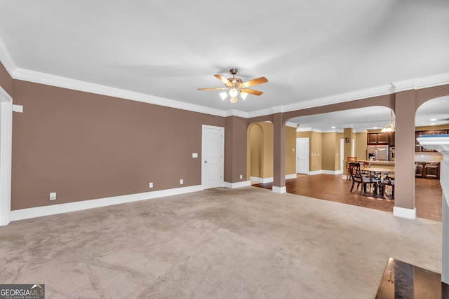 80 Lanier Rdg, Acworth, GA 30101 - unfurnished living room with ceiling fan, arched walkways, crown molding, and carpet