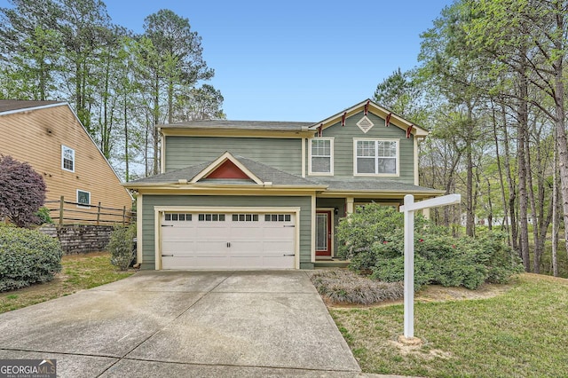 traditional-style home with fence, a shingled roof, a front lawn, concrete driveway, and an attached garage
