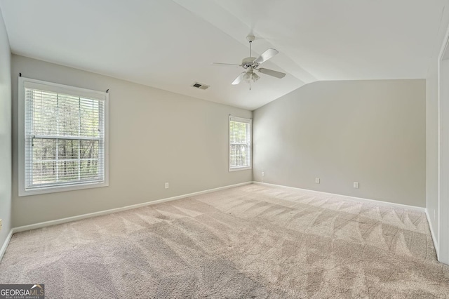 unfurnished room with baseboards, carpet, visible vents, lofted ceiling, and ceiling fan