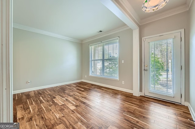 interior space with hardwood / wood-style floors, a wealth of natural light, and ornamental molding