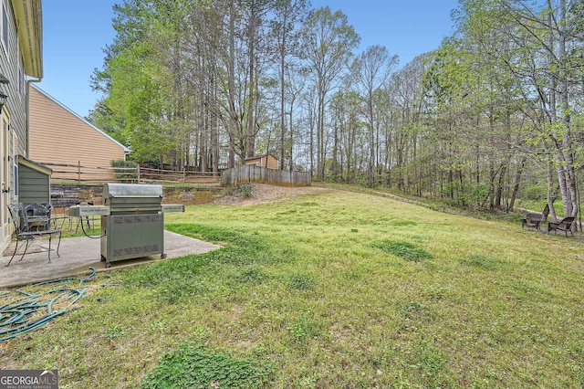 view of yard featuring fence and a patio